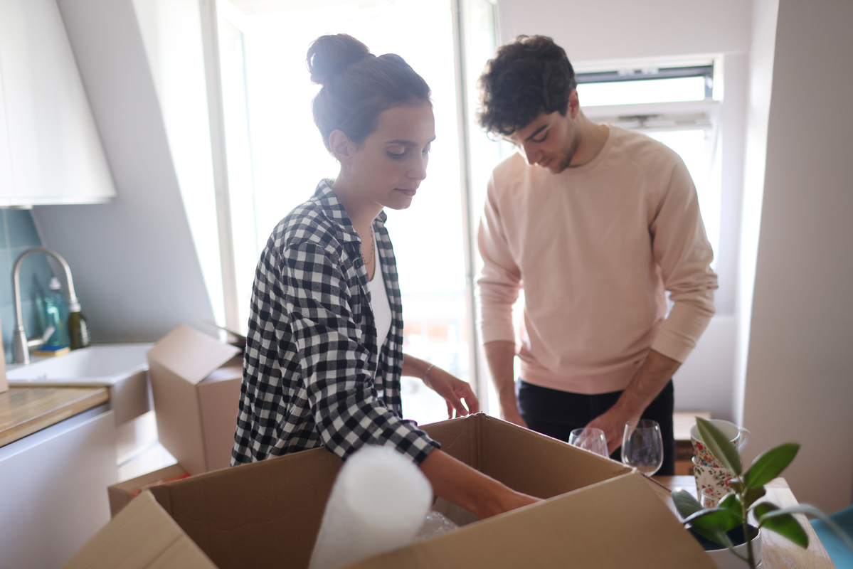 A couple unpacking boxes in the kitchen