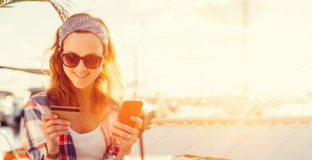 Woman using credit card to make a purchase online