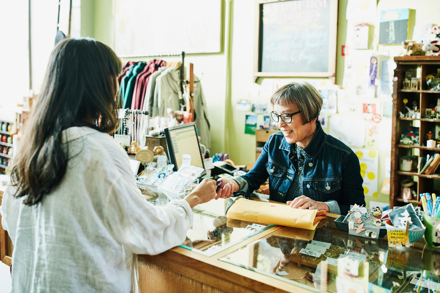 Woman serving a customer in a shop