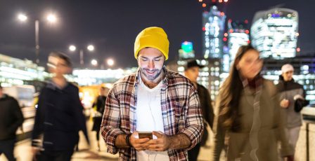 Man looking at his phone in a European city