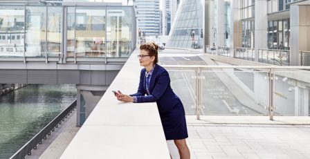 Businesswoman looking at her phone outside