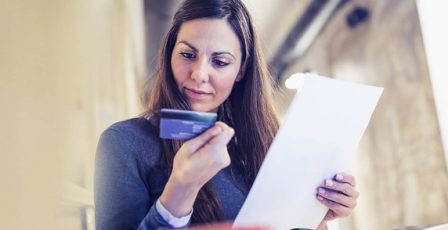 Woman looking closely at her credit card