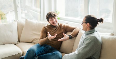 Two people chatting on the sofa