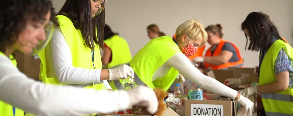 Charitable organisation workers packing donation boxes