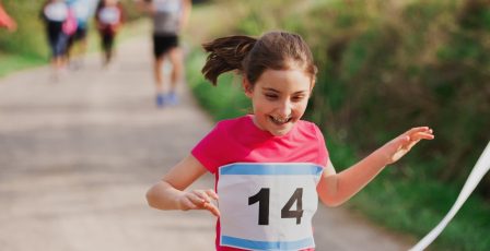 Young girl finishing a charity run