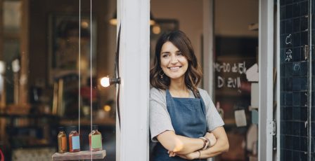 Business owner standing outside her shop