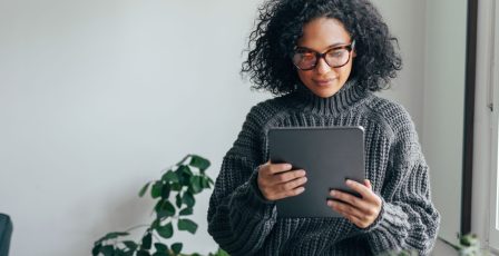 Woman learning financial literacy and numerical confidence on a tablet