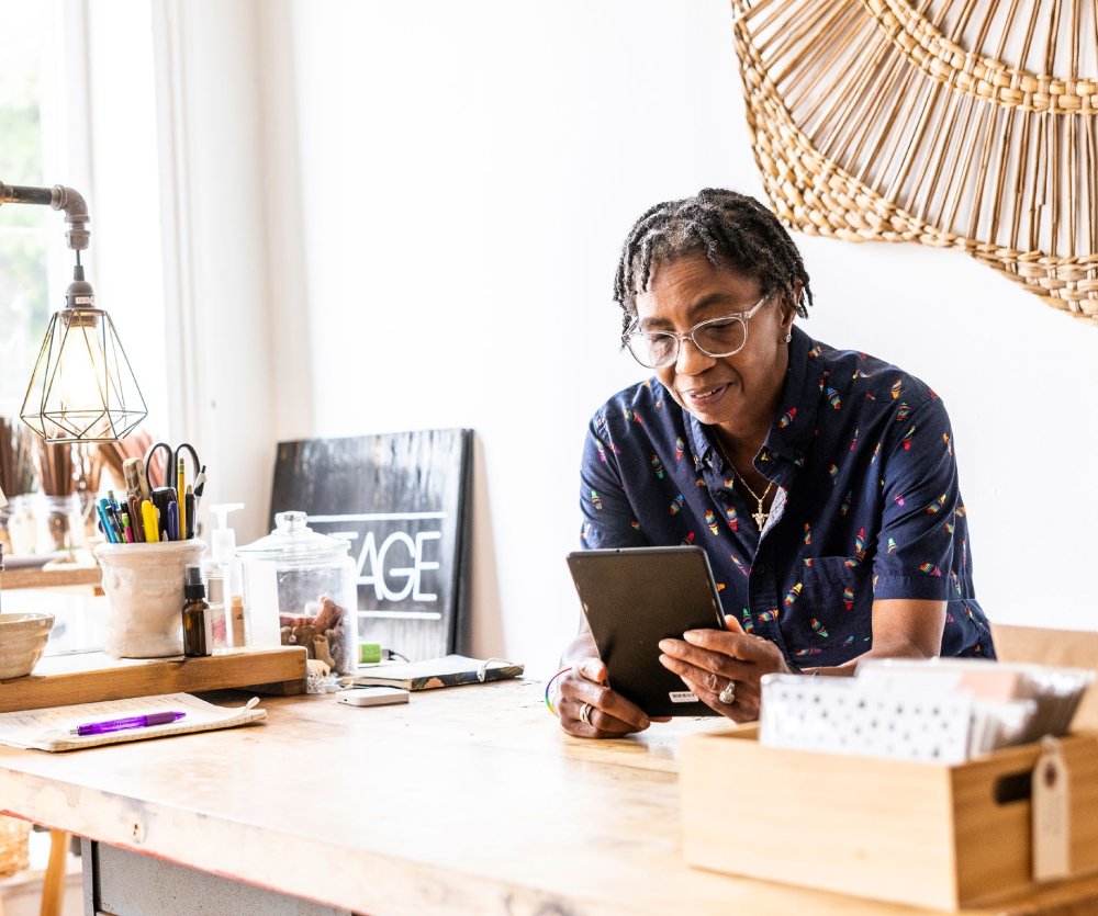 Mature woman learning financial literacy and numerical confidence on a tablet