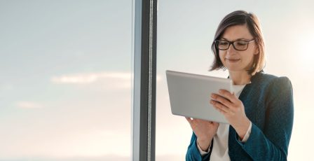 Business woman reviewing donor data on tablet