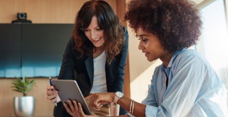 Charity workers looking at gift aid data