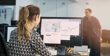 Colleague looking at map data on her computer