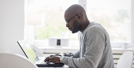 Man using laptop while working from home