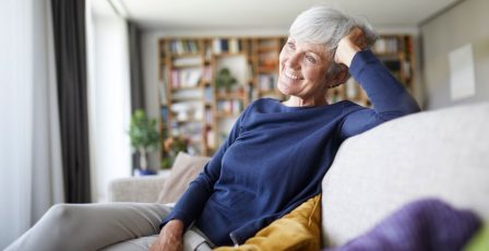 Mature woman sitting at home on her new sofa