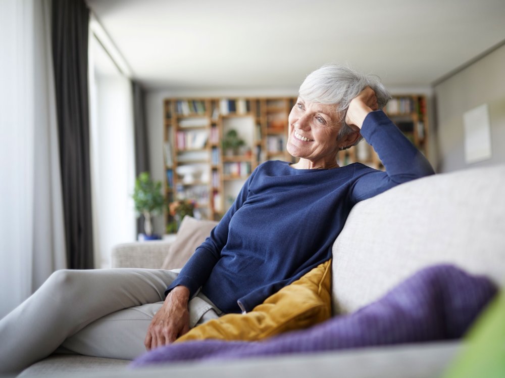 Mature woman sitting at home on her new sofa