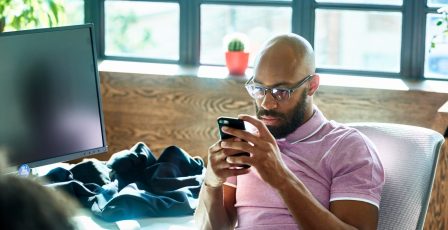 Man using his mobile phone for online gaming