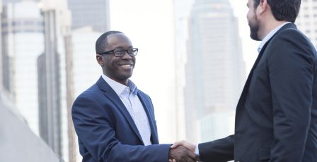 Government official shaking hands with business owner