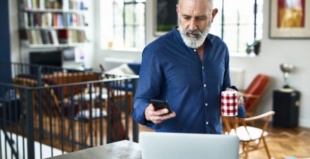 Mature man looking at his emails on his phone