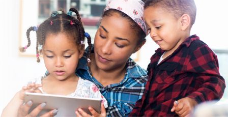 Family spending time together looking at a tablet