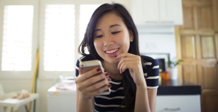 Young woman using her phone to check her social media accounts