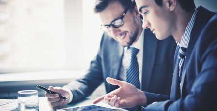 Two colleagues looking at data