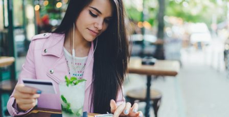 Person at a coffee shop making a payment on their mobile device