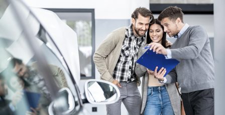 Couple buying a car in a showroom