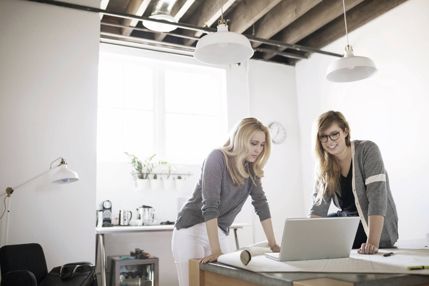 Two colleagues looking at business data