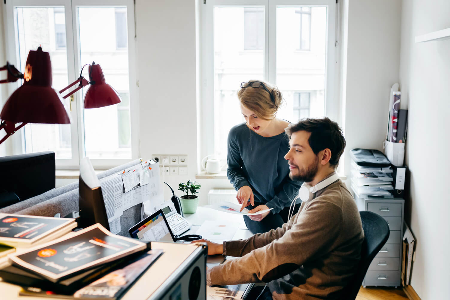 Two colleagues looking at data