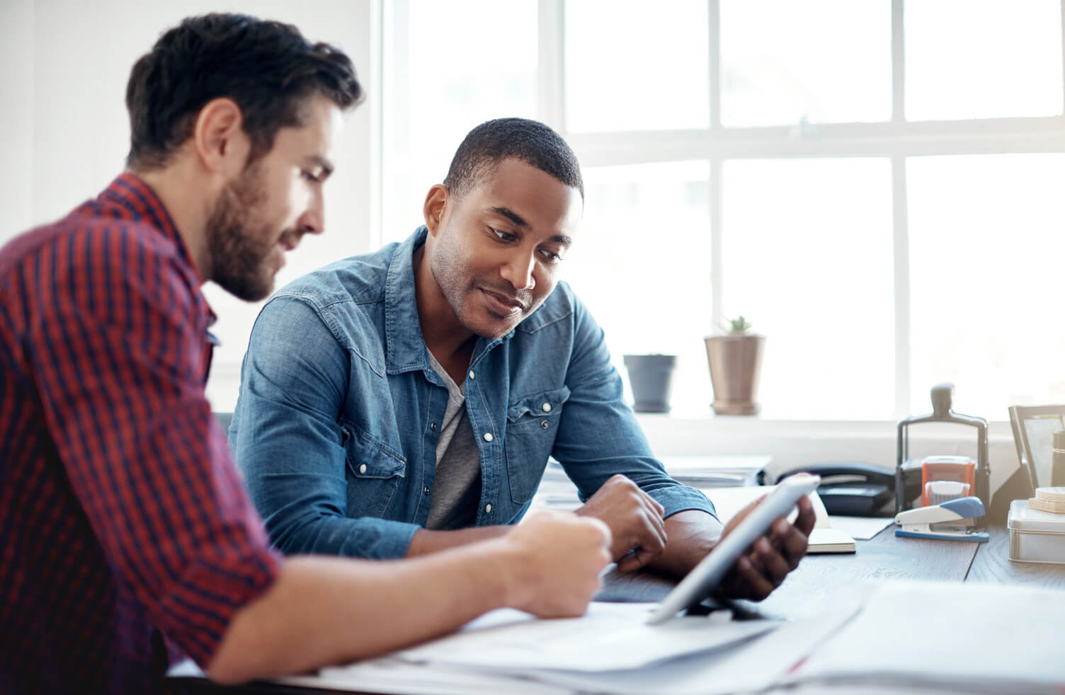 Two colleagues discussing data in an office