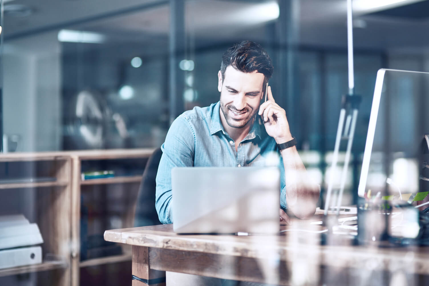 Man on his laptop and the phone