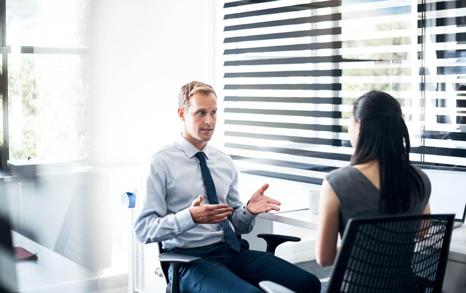 Two colleagues talking in an office