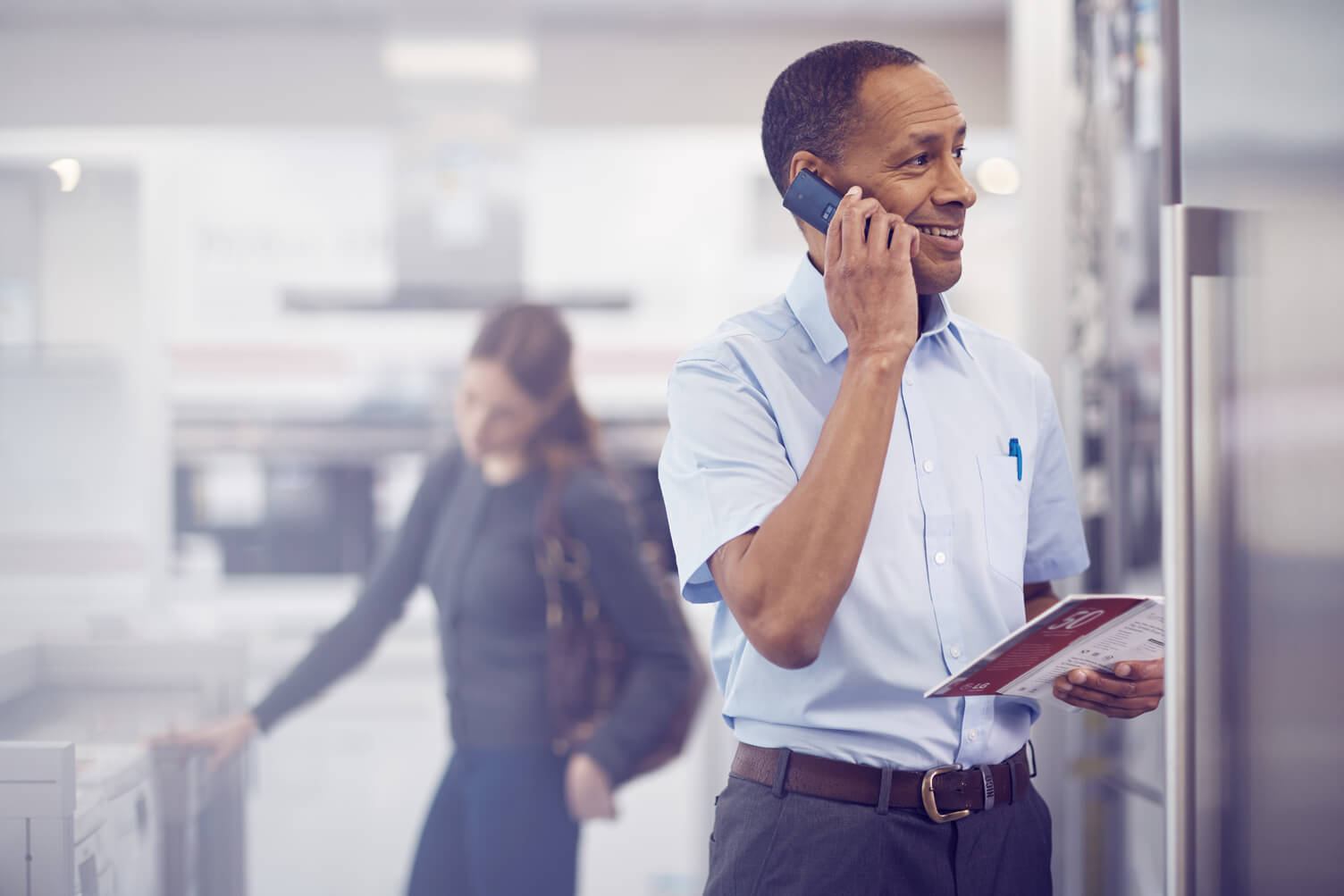 Man on the phone in kitchen