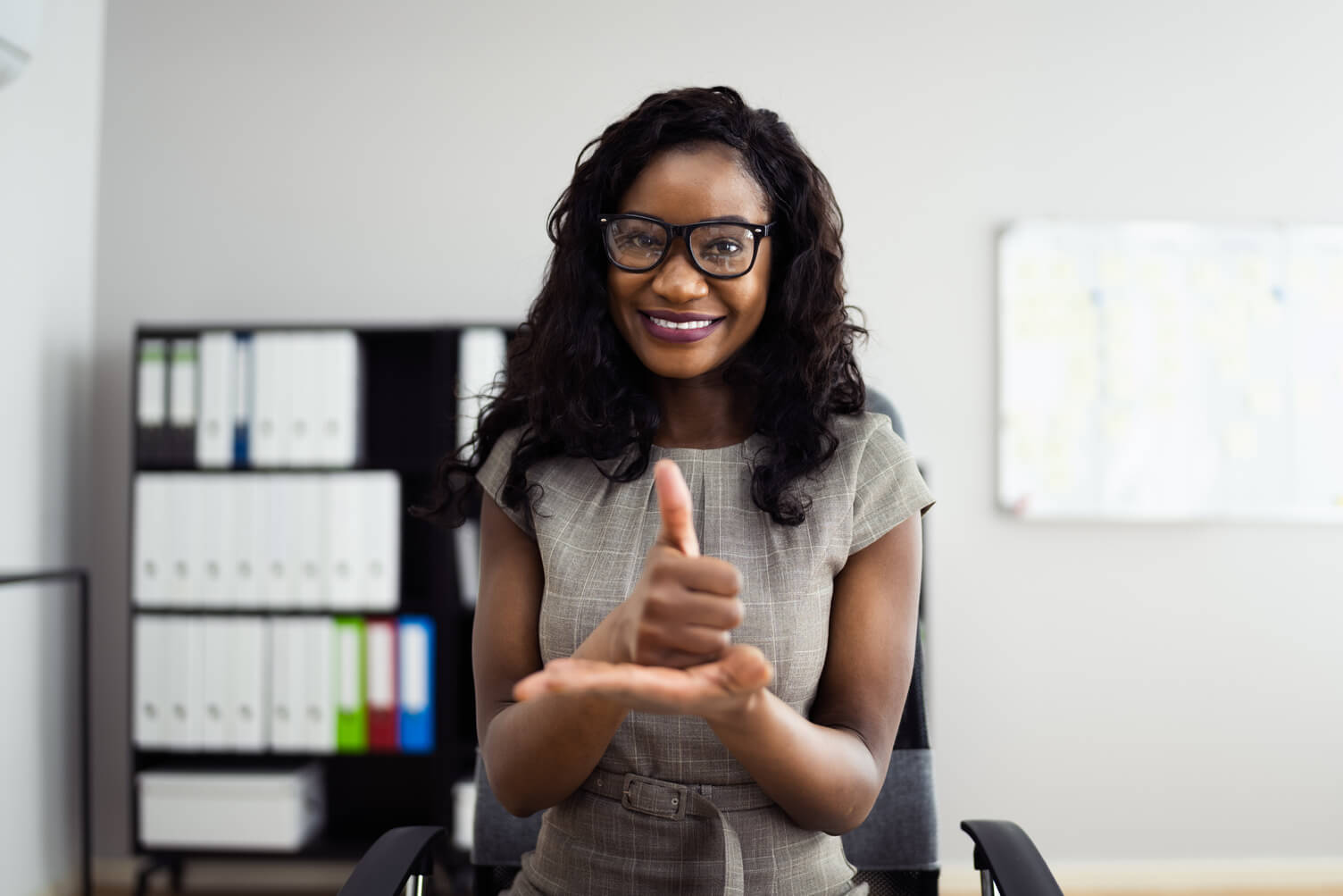 Lady giving a thumbs up following a good KYC check 