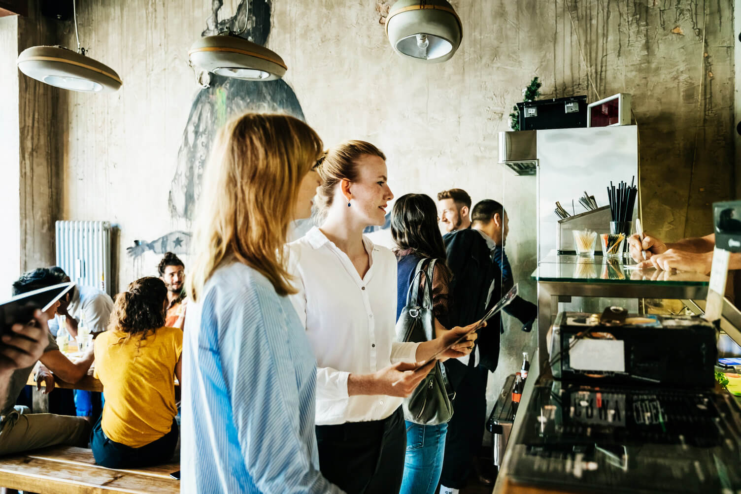 Two women ordering food from a cafe