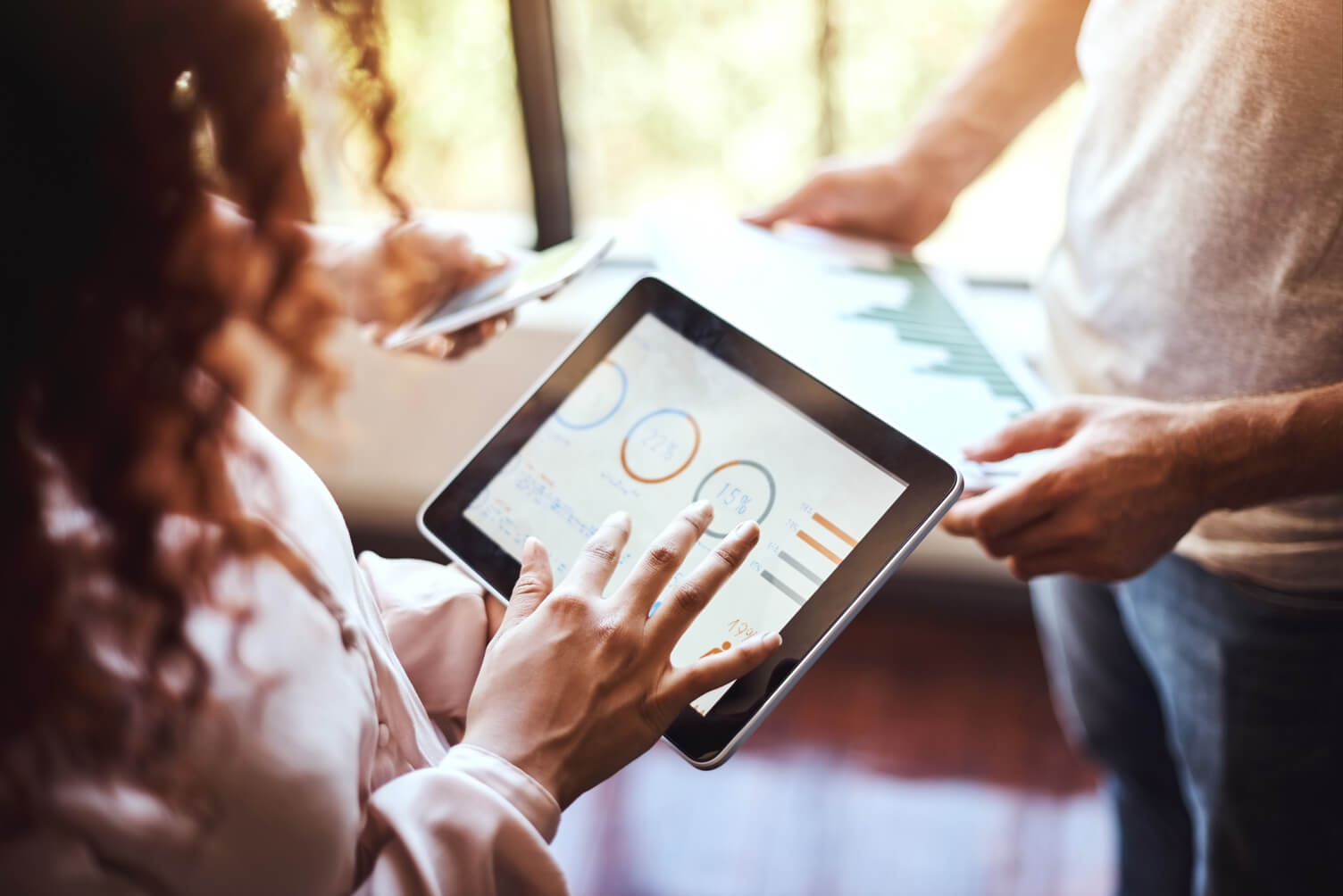 A woman looking at data on a tablet