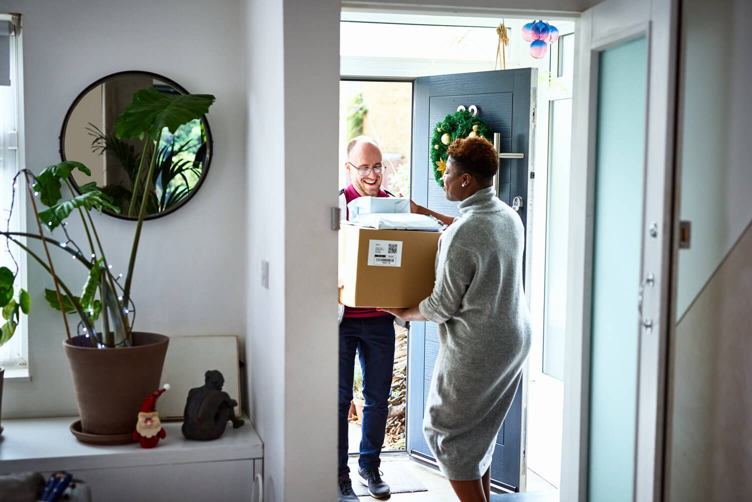Delivery driver handing over a box to a customer