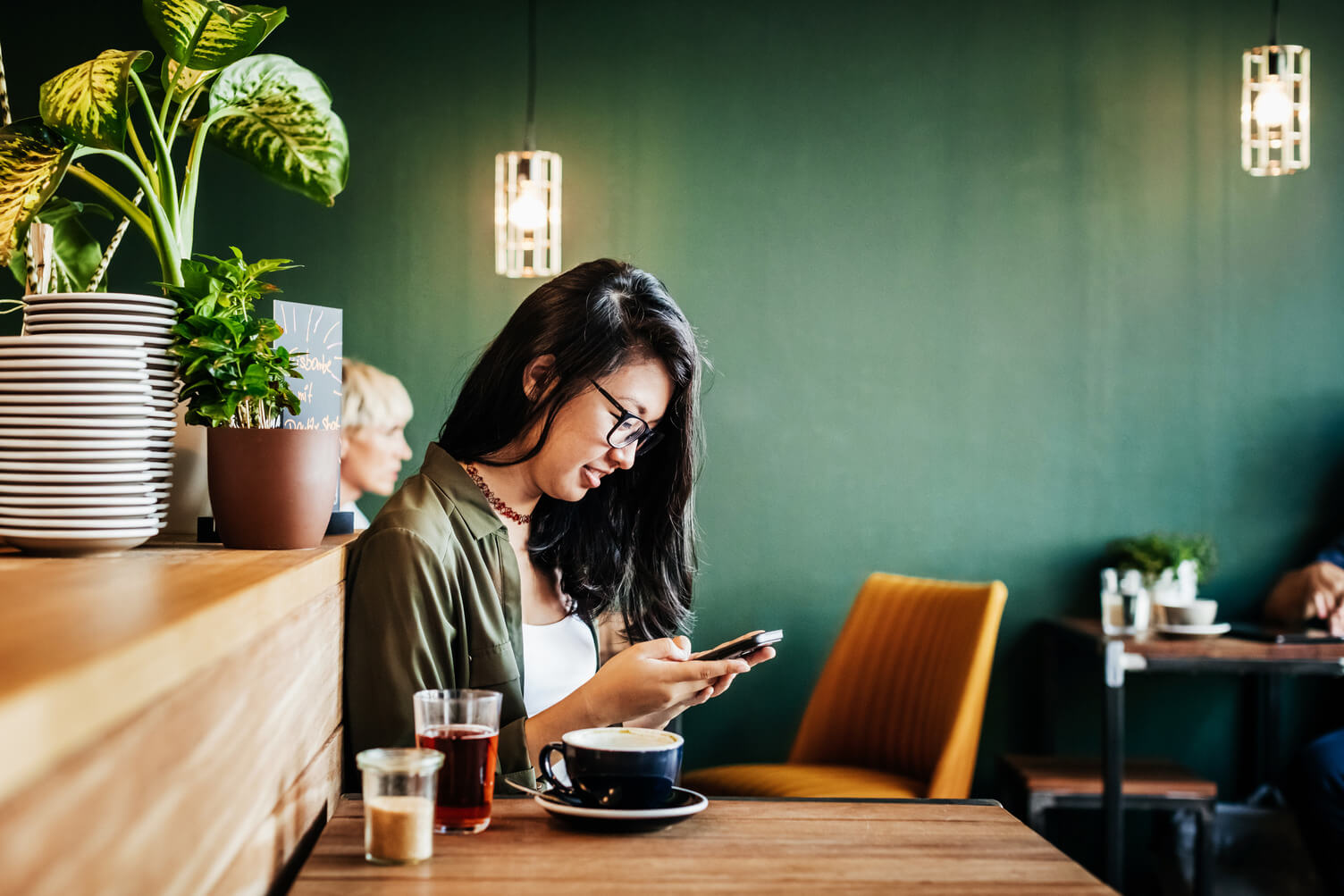 Young woman online gaming in a cafe