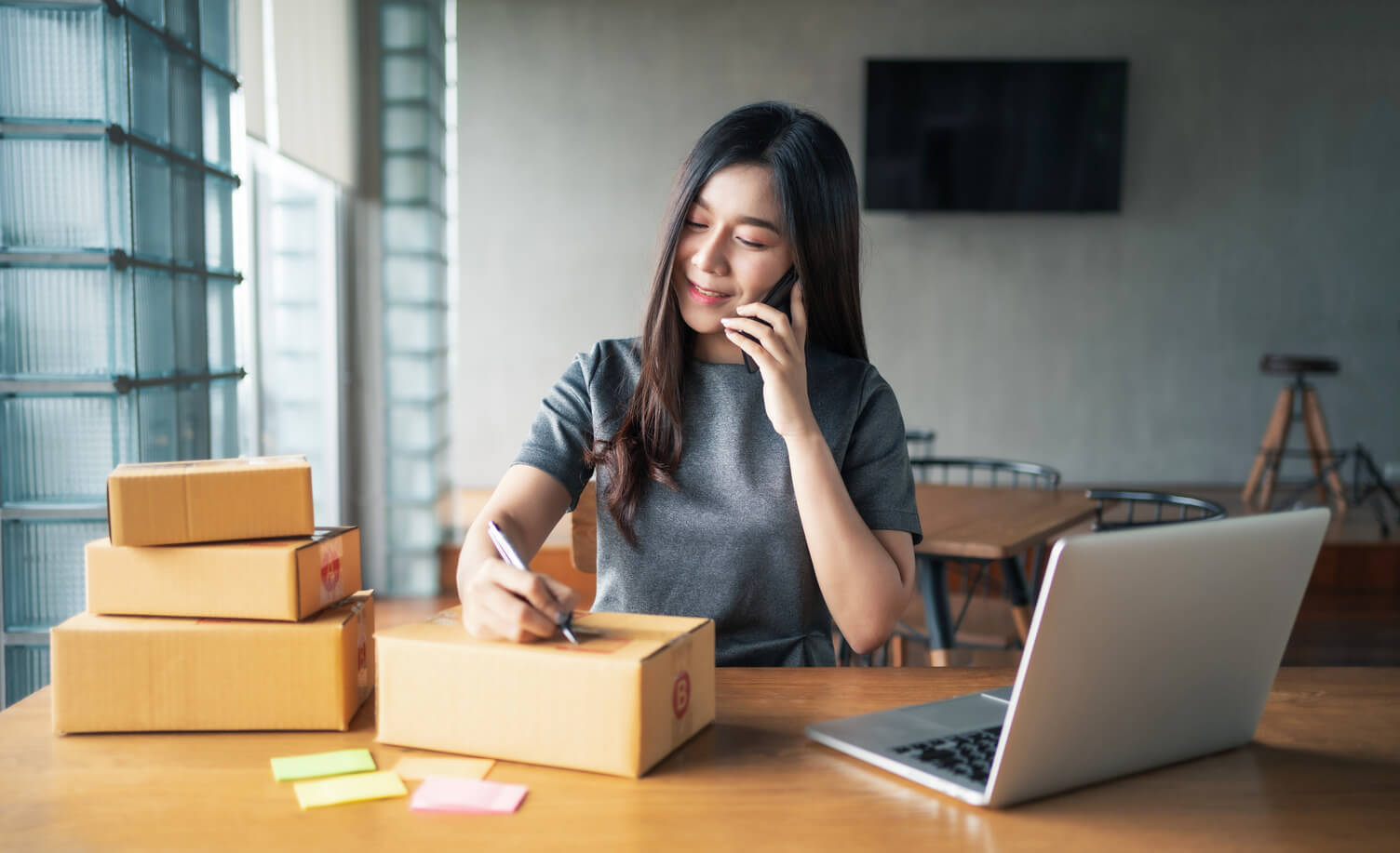 Woman validating customer addresses over the phone