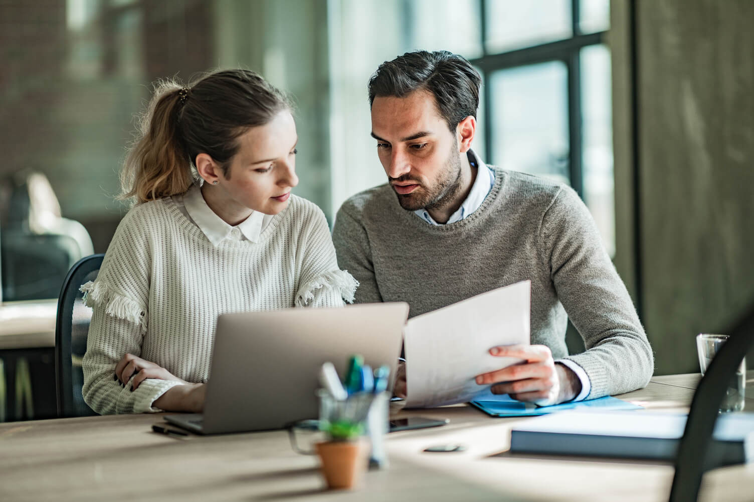 Two colleagues looking at a report