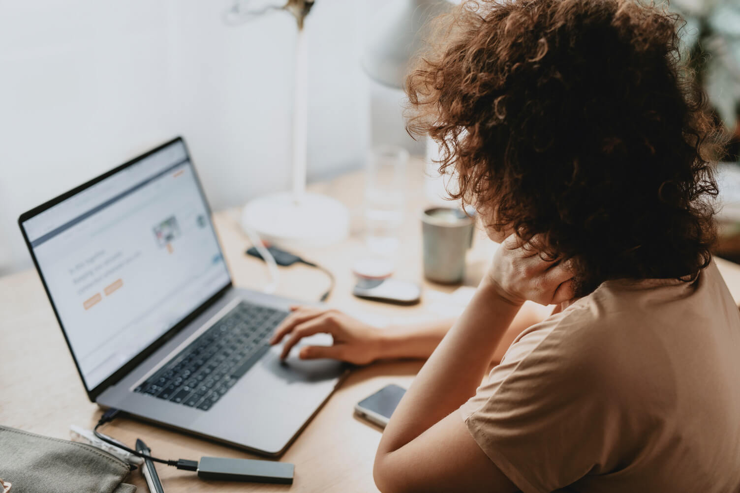 Woman looking at products on a laptop