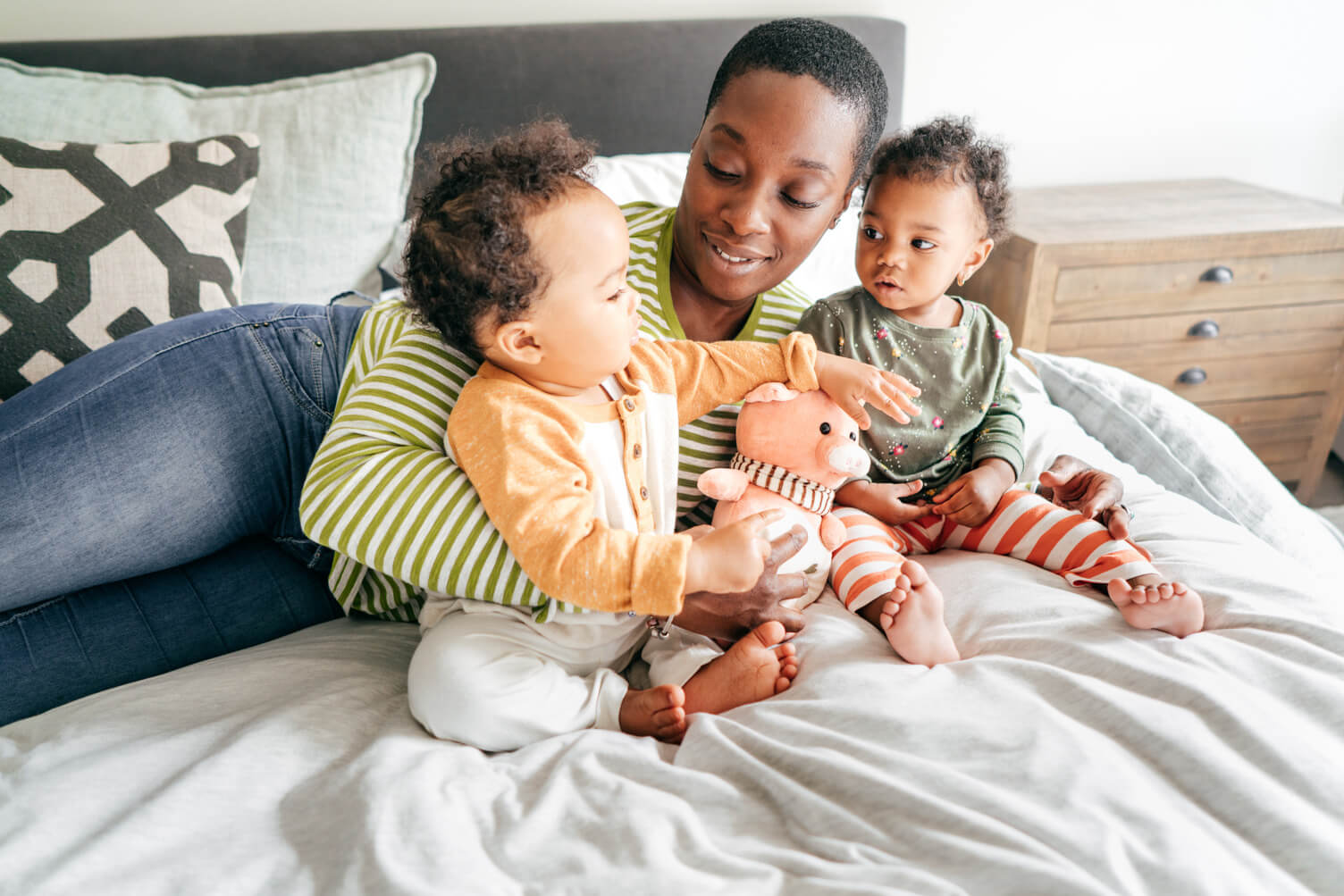 Mother with babies in bed