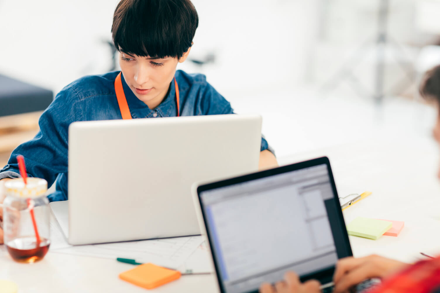 Two employees using their laptops