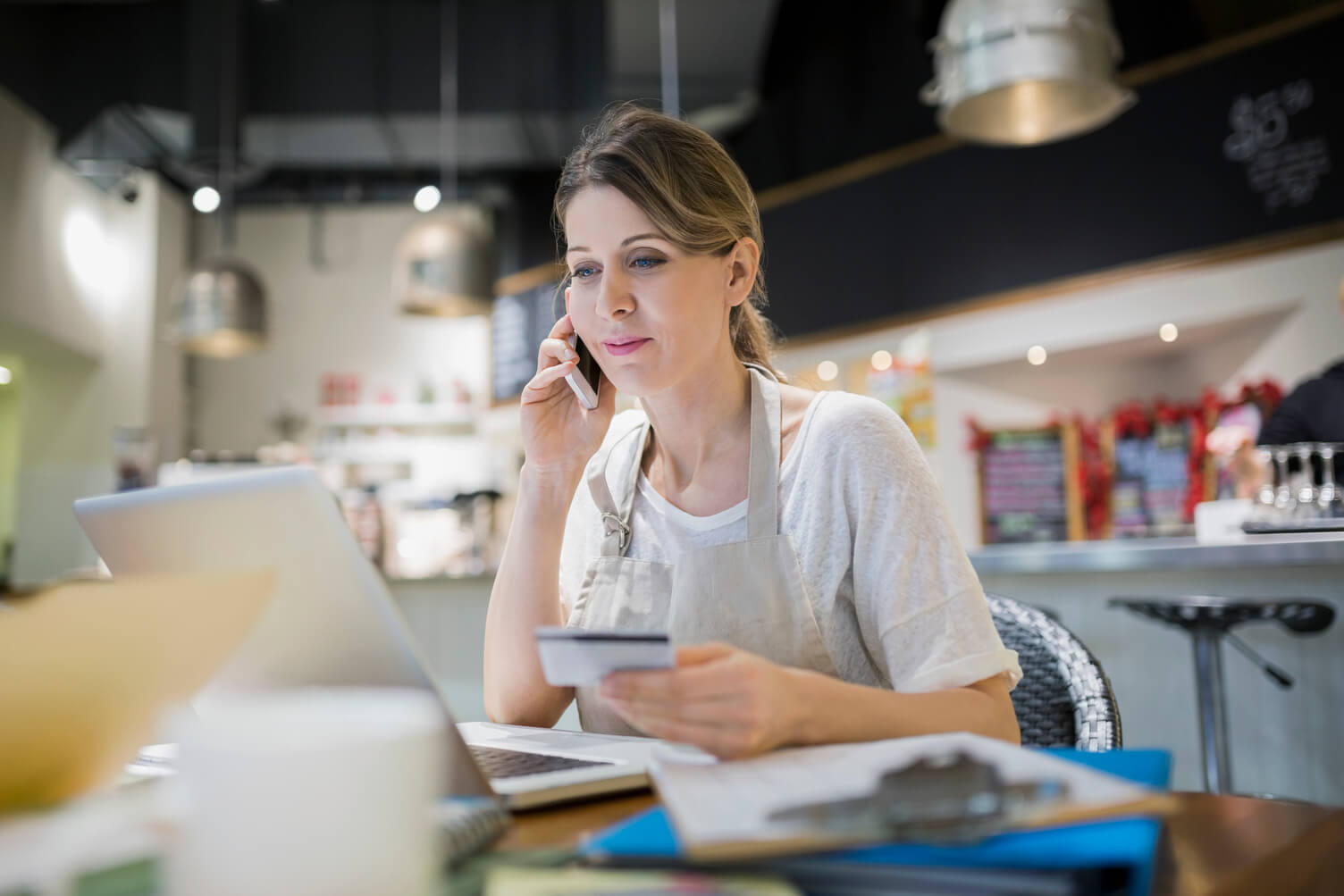 Lady on phone with credit card talking to bank