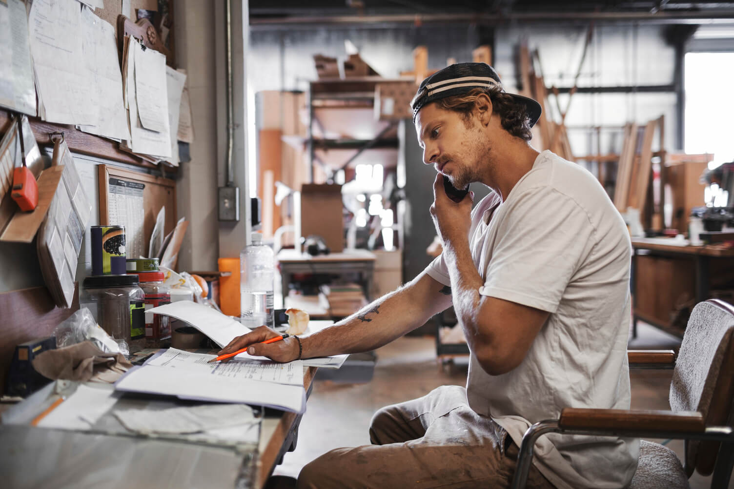 A man sat working while on a phone