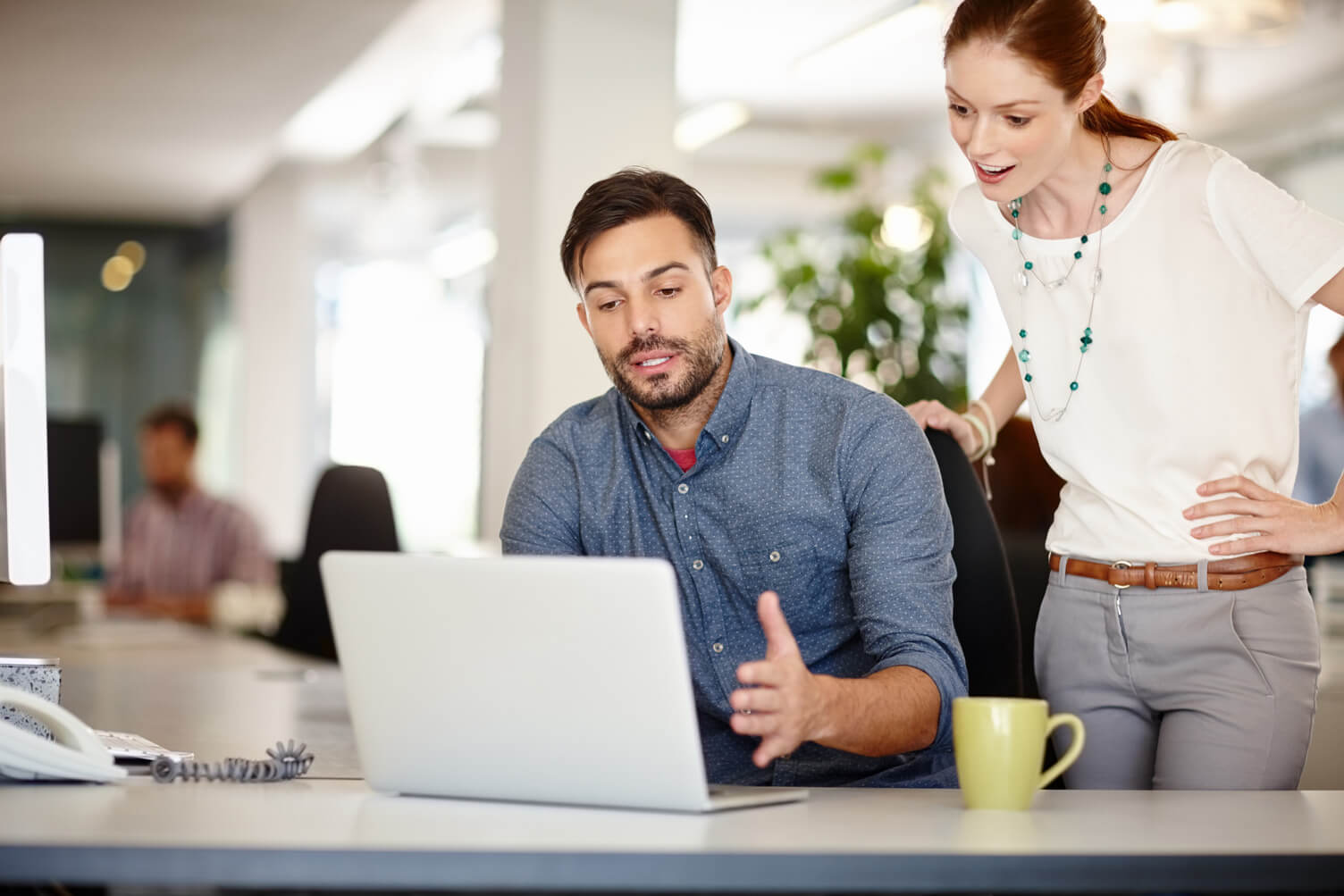 Two employees looking at a computer