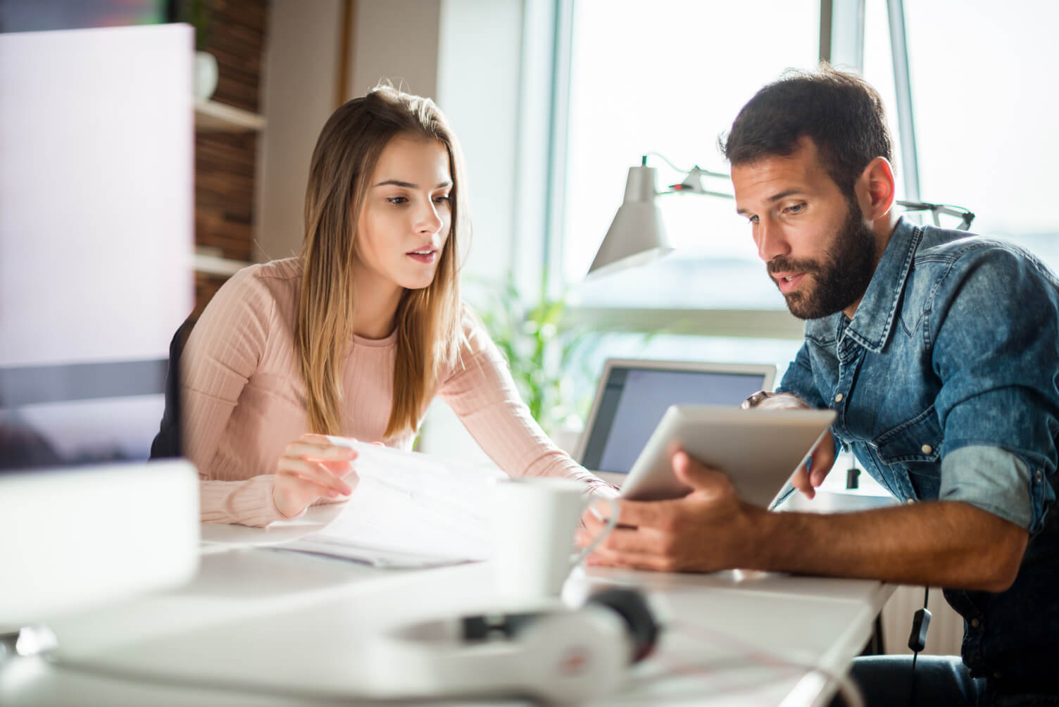 Two colleagues at a small business reviewing data