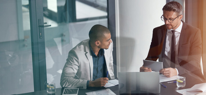 Two colleagues looking at fraud data