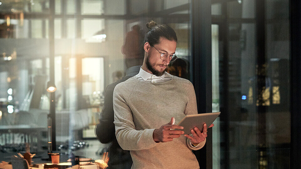 Man looking over fraud statistics on a tablet