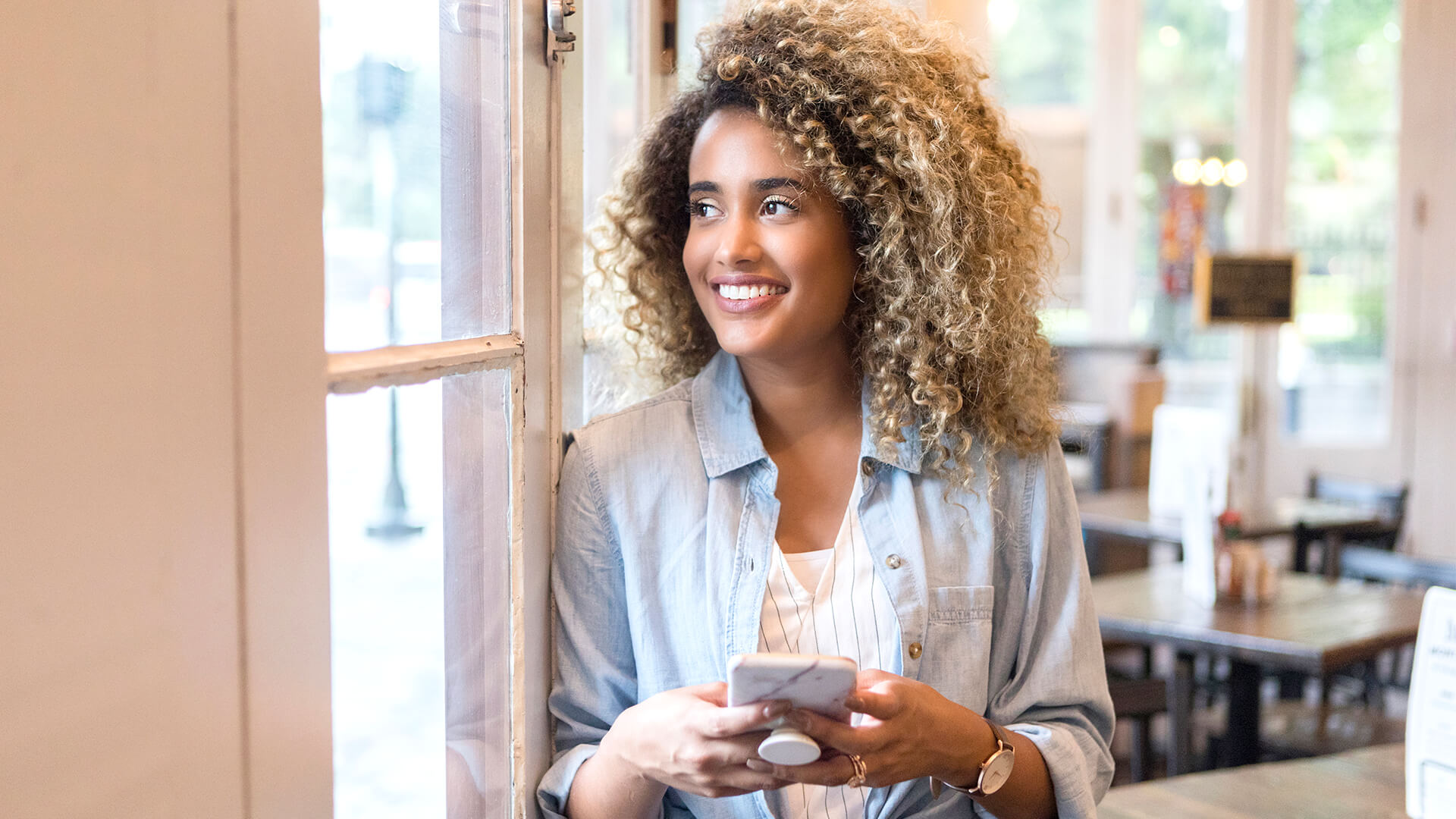 Woman smiling with her mobile phone