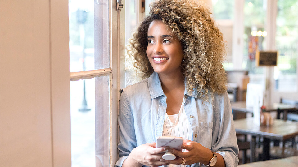 Woman smiling while looking out window